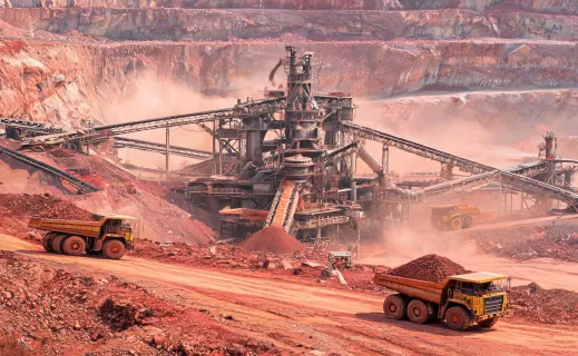 Iron-ore quarry cone crusher with haul trucks